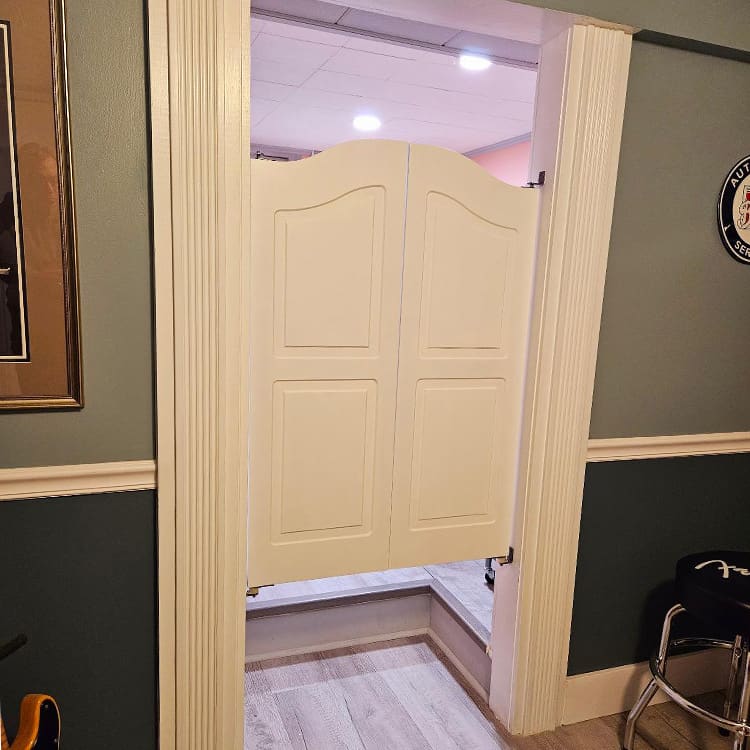 white swinging doors between living room and kitchen